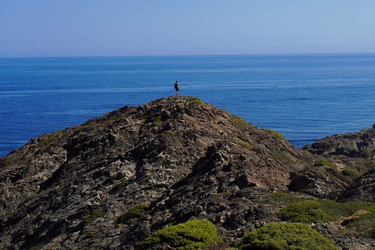 a person standing on a rocky cliff